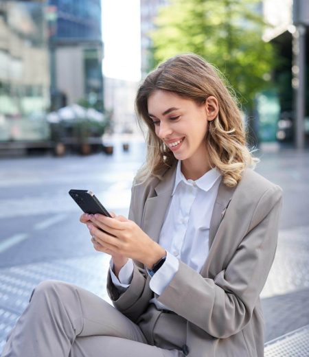 vertical-shot-smiling-businesswoman-looking-smartphone-app-sending-message-mobile-phone-ode_1258-118769 vertical-shot-smiling-businesswoman-looking-smartphone-app-sending-message-mobile-phone-ode_1258-118769